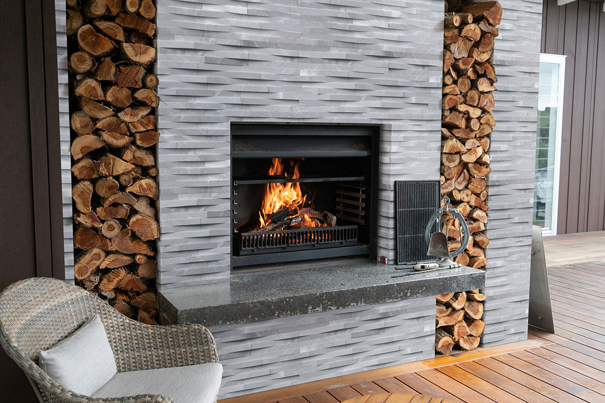 Rockmount 3D Natural-Stone Stacked Stone Panel — installed room view — color Cosmic Gray Wave Panel