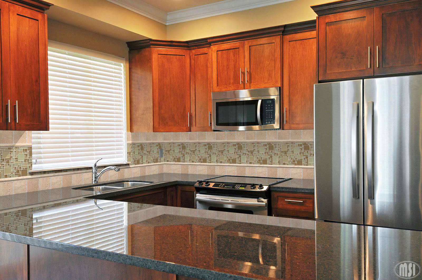 Ubatuba 12x12 Polished Granite Tile — installed room view — color Green-black with gold, gray and green speckles